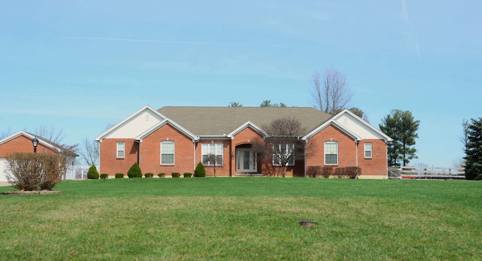 Brick ranch house with a freshly mowed front lawn