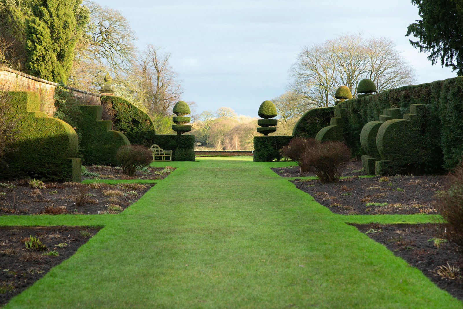 Long manicured green lawn with mature trees