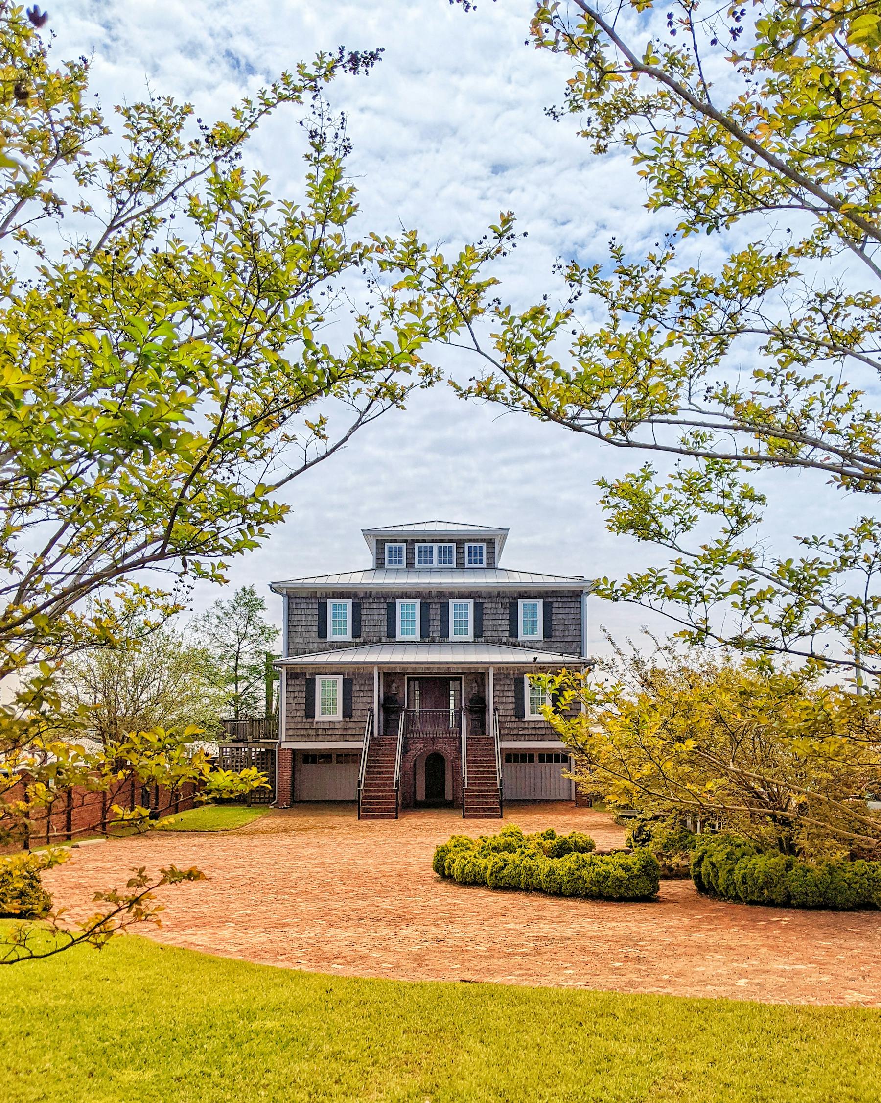 Brick Southern home with spring foliage and trimmed lawn, Madison area