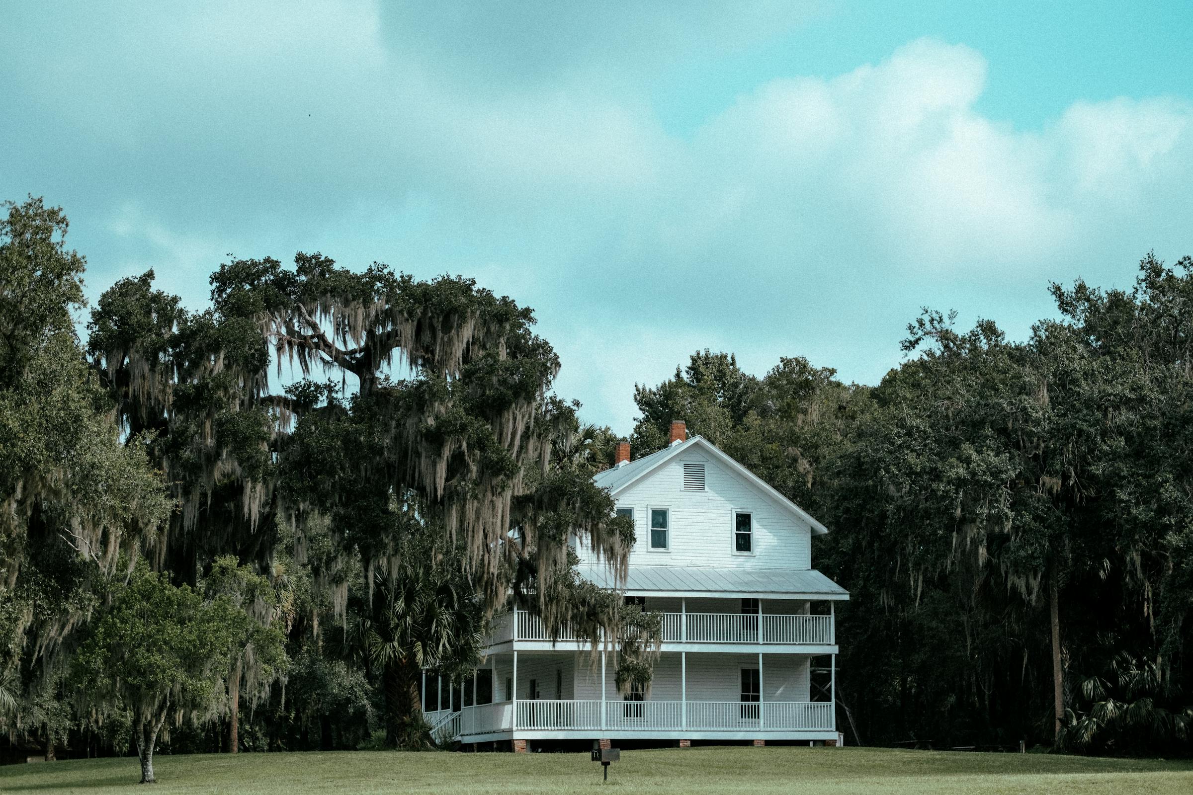 White clapboard house with mature shade trees, Tennessee Valley residential